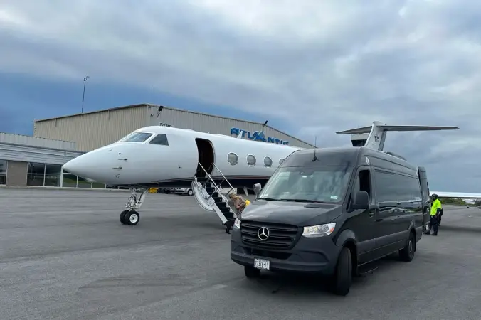 Private jet and Sprinter van on the tarmac for VIP airport transfer