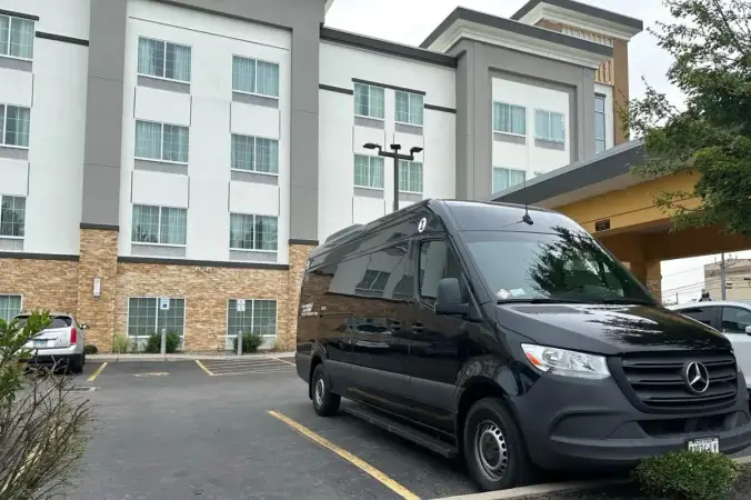 Sprinter van waiting at a hotel entrance for private transfer guests