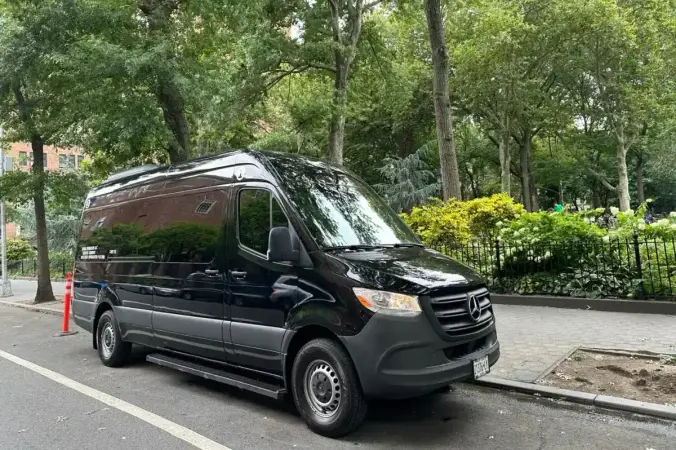 Black Mercedes Sprinter van parked for private NYC airport transfers